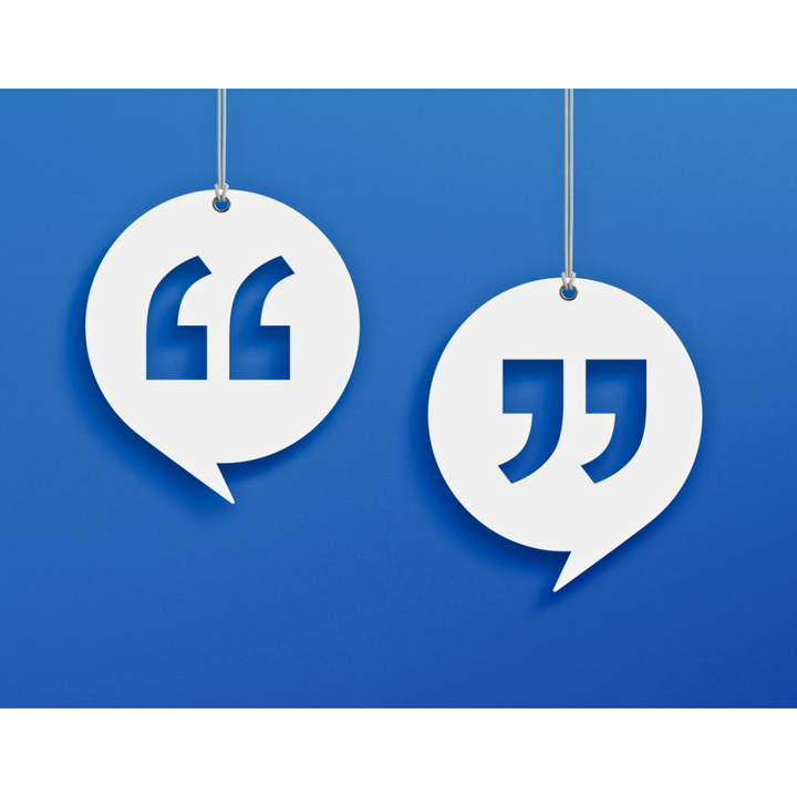 Two white speech bubble cutouts with quotation marks hanging on strings against a blue background.