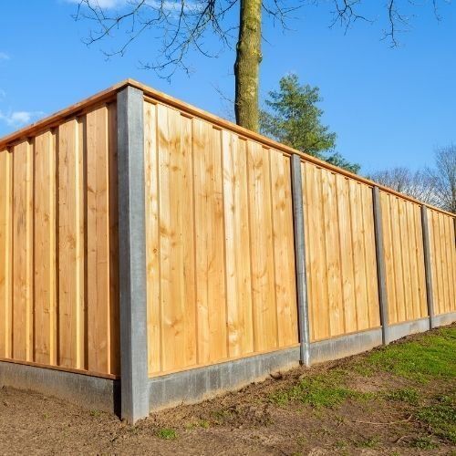 A new built fence by Landscaping Leicester it has Concrete posts and boards with wooden panels
