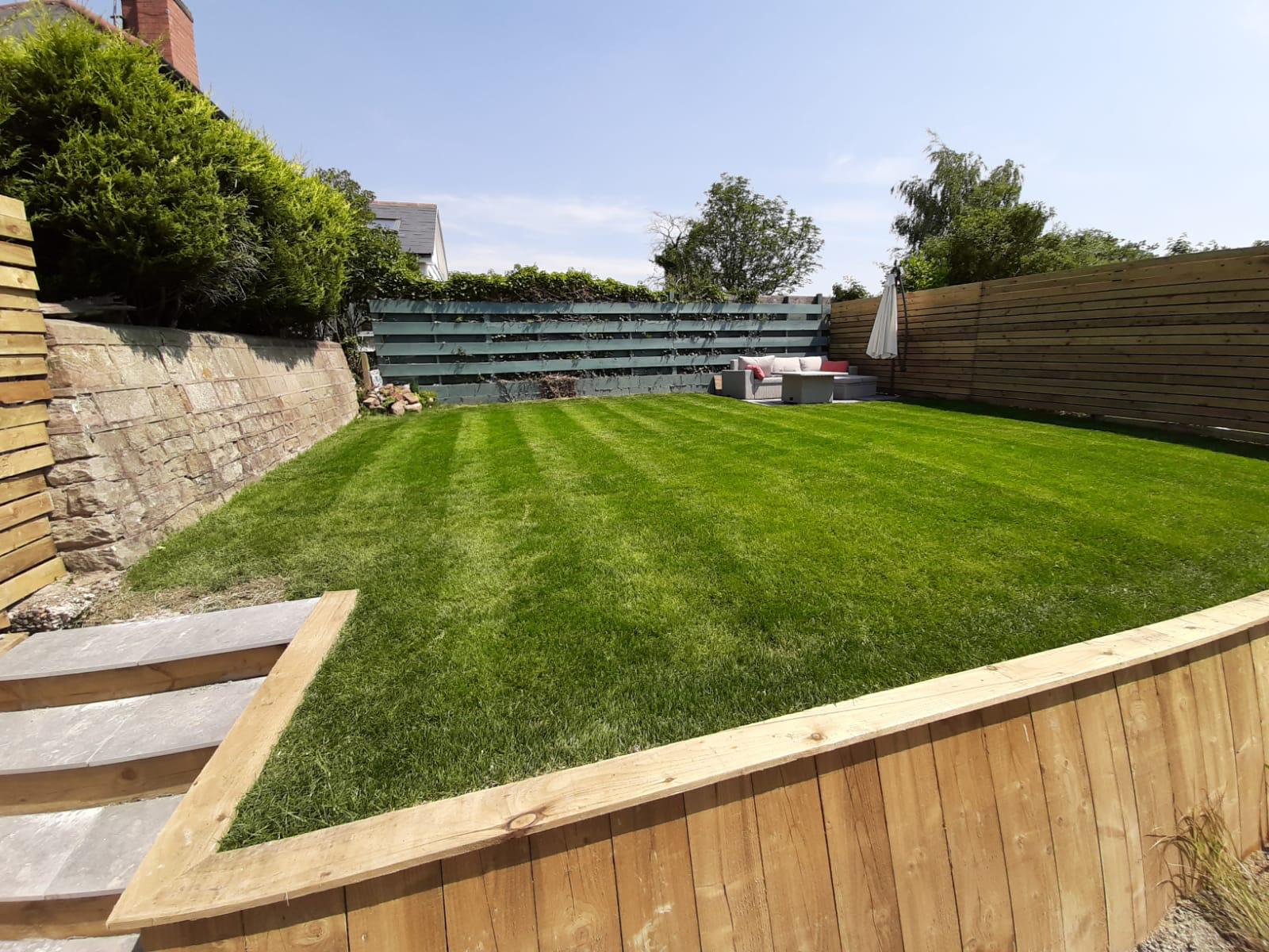 This is a picture of a large turfed grass area which had just been mowed by Landscaping Leicester in a garden in Leicester