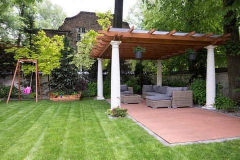 A picture of an outdoor seating area covered by a Pergular