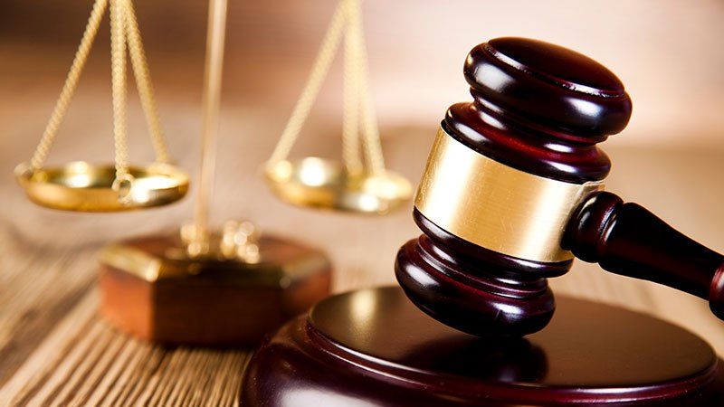 gavel with justice scales in the background