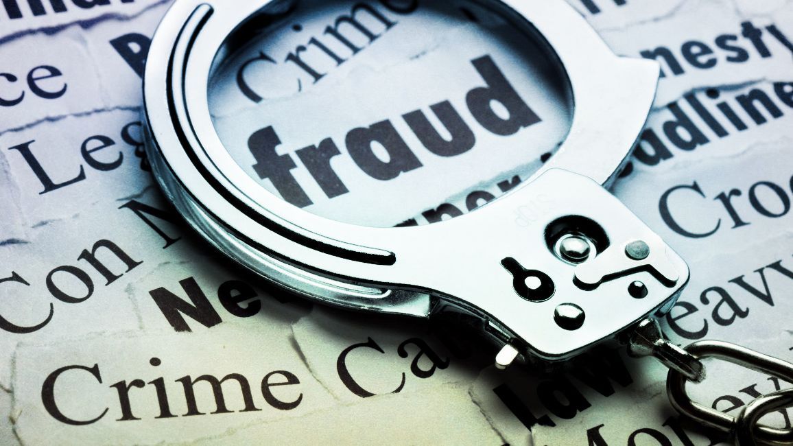Handcuffs over newspaper headlines including