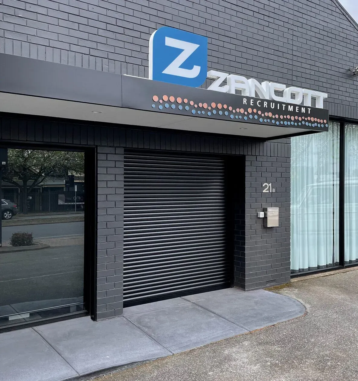 Dark building entrance with a closed roller shutter, 