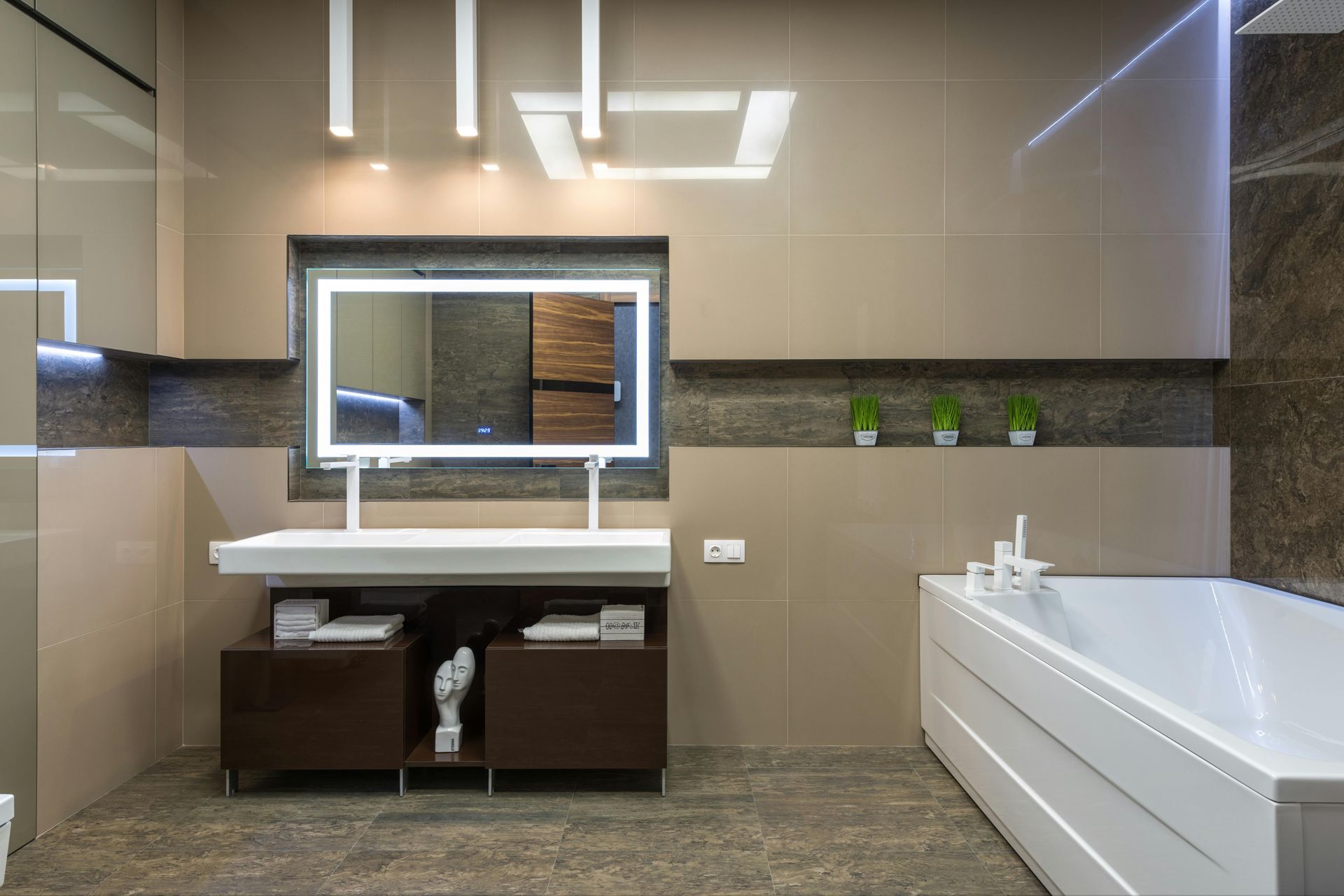 A bathroom with a bathtub , sink and mirror.