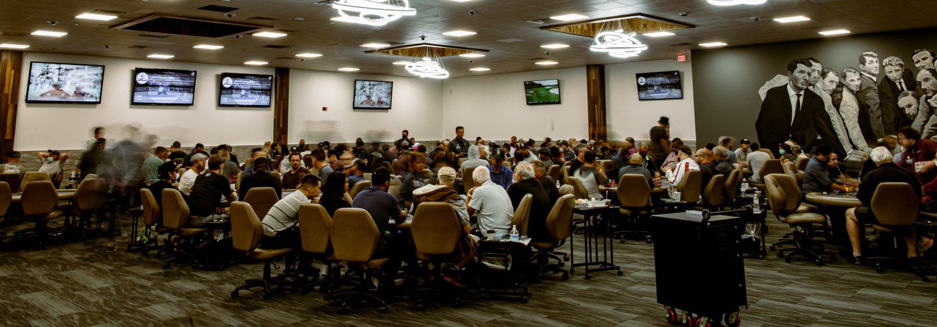 Full poker tables in large room in casino