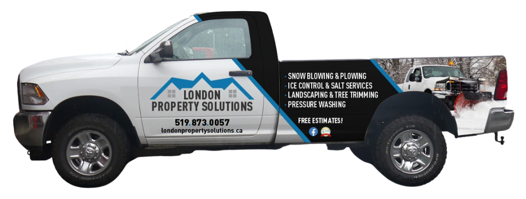 A white truck with a black and blue wrap on the side.