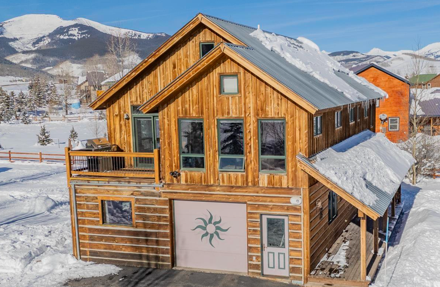 Wooden house with snow-covered roof in a snowy mountain village