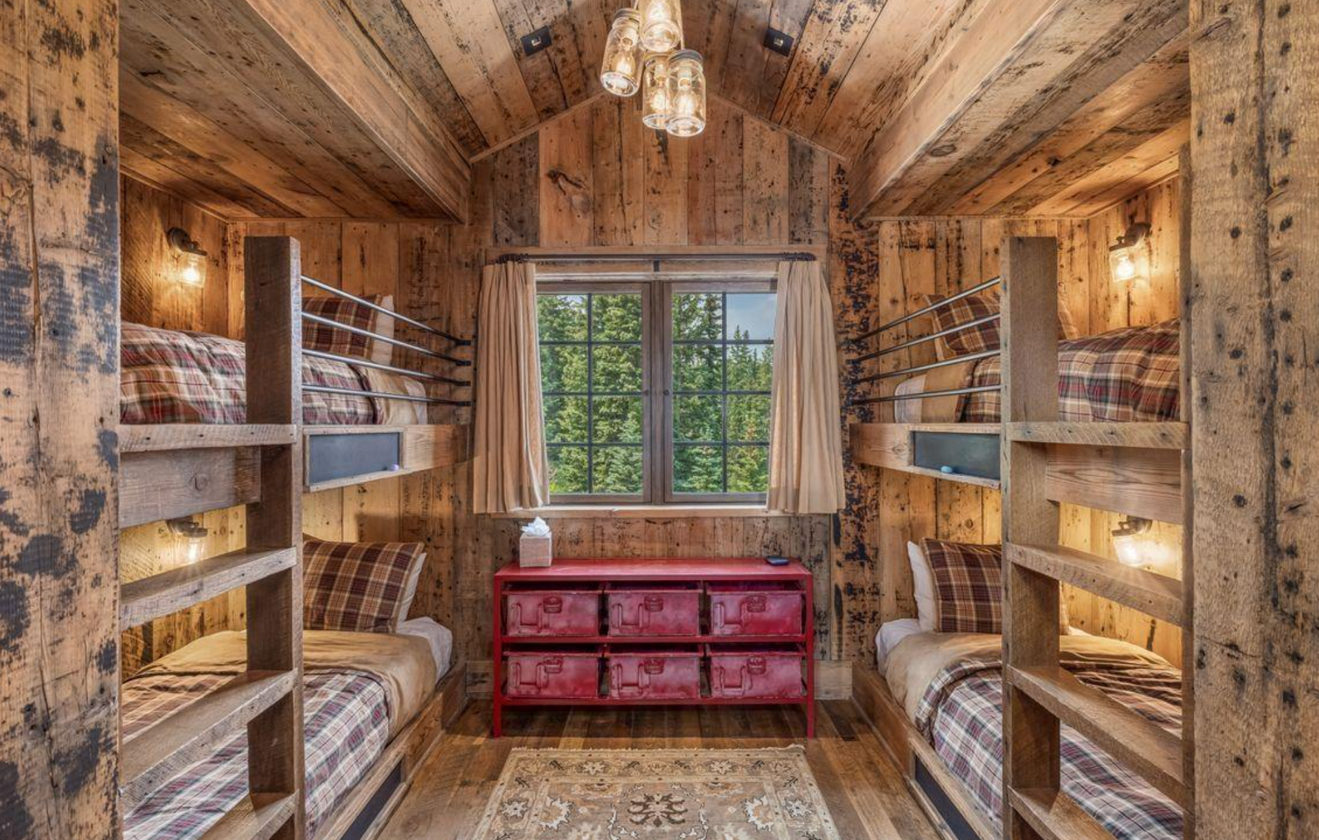 Cozy rustic pantry with wooden shelves, woven baskets, and a red cabinet beneath a window