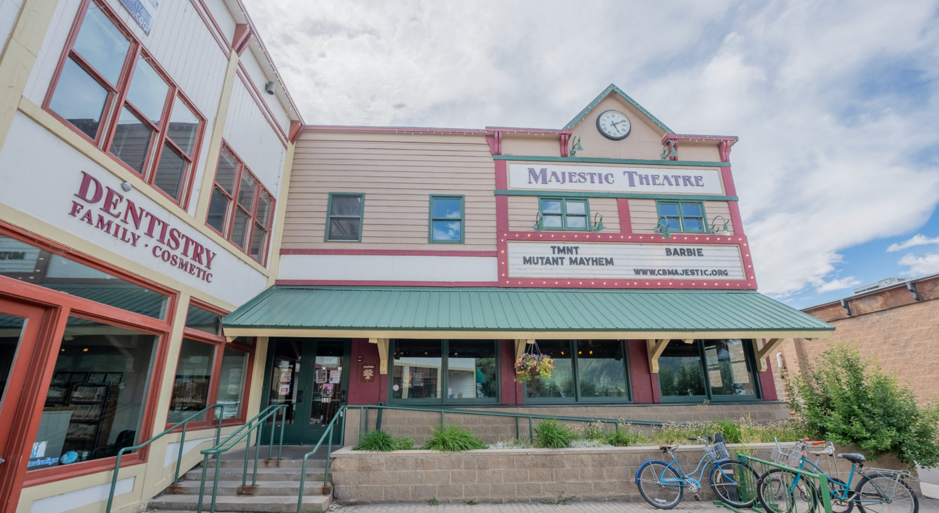 Old western-style storefront with “Dentistry” and “Minstrel Theatre” signs, green awning, and bicycle rack