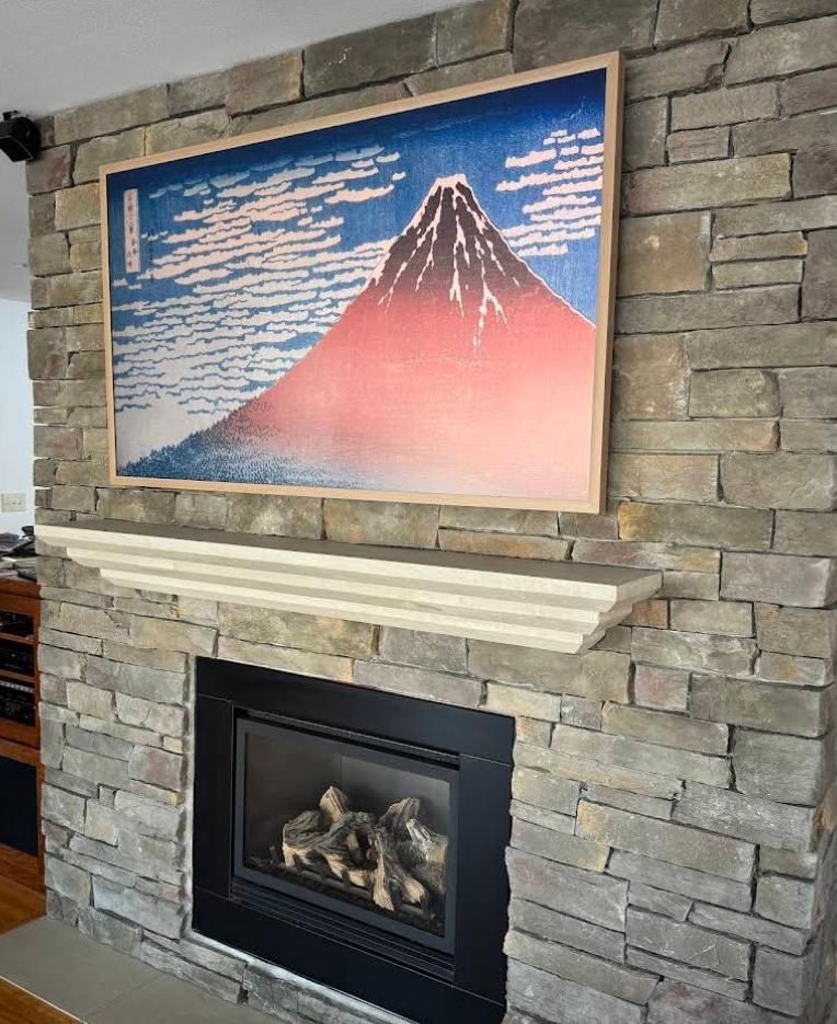 Stone fireplace with a framed Mount Fuji print above the mantel.