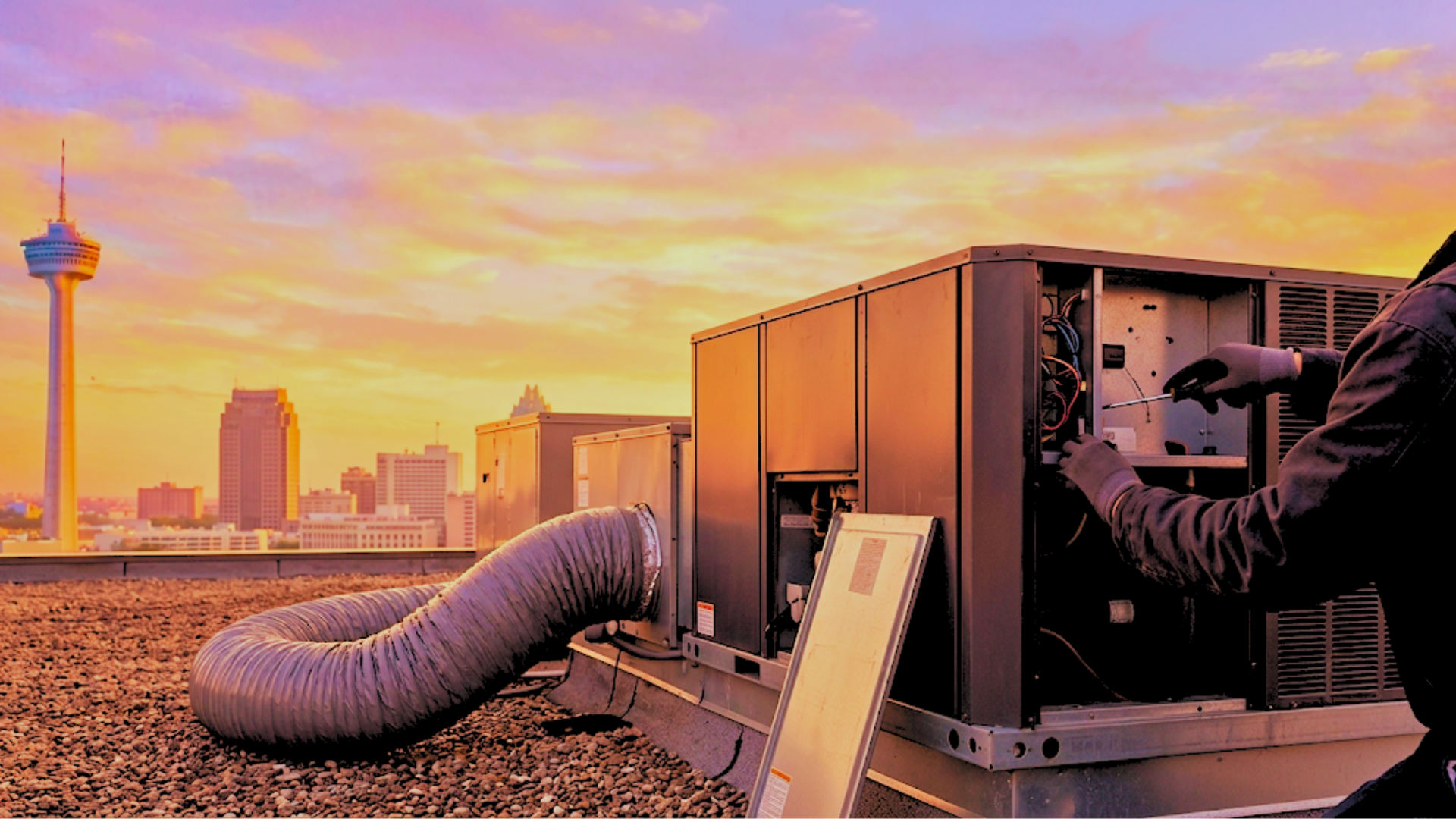 Technician holding gauges and giving a thumbs-up beside an outdoor air conditioning unit