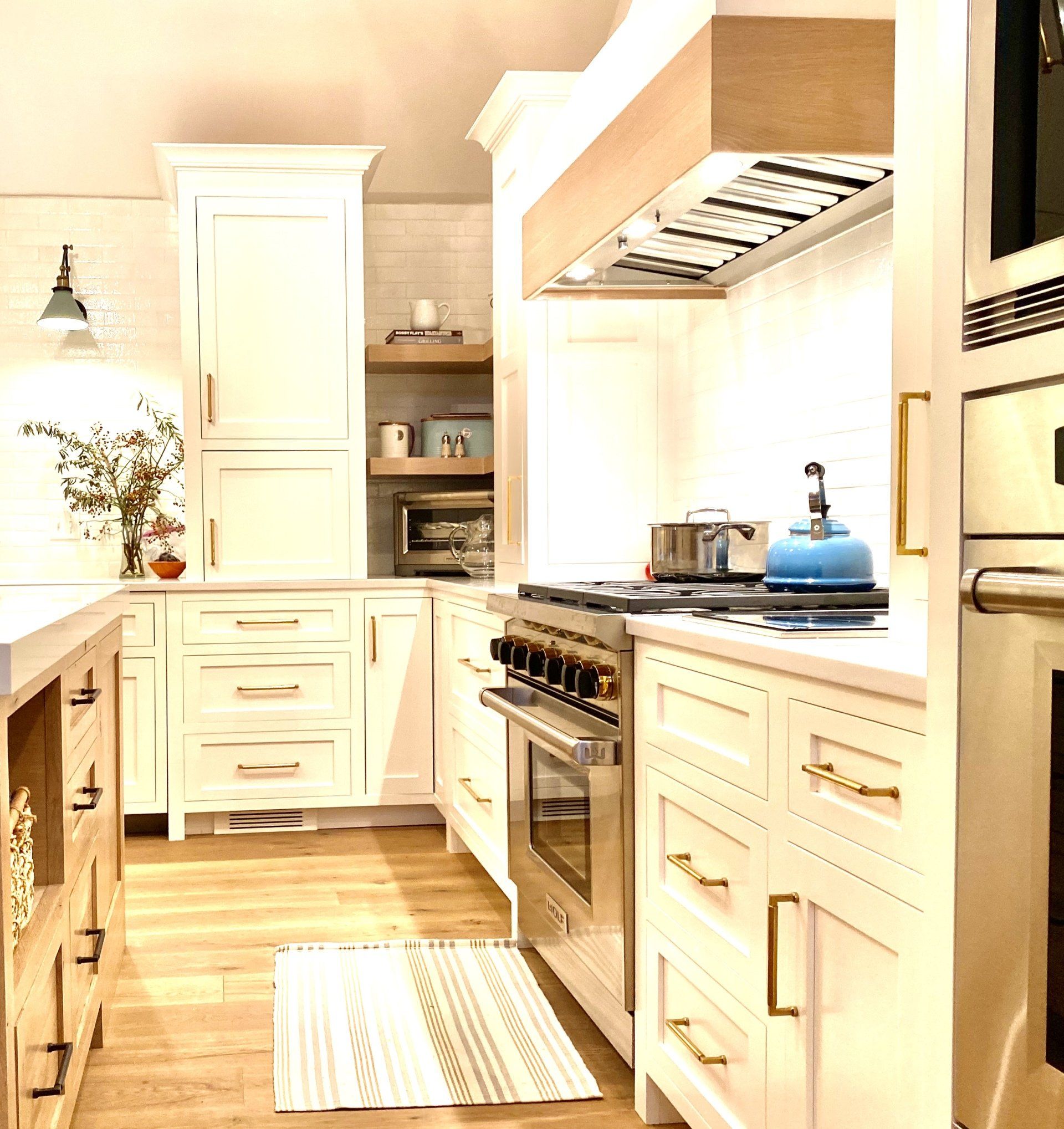 kitchen with white cabinets, silver appliances, and wooden floors