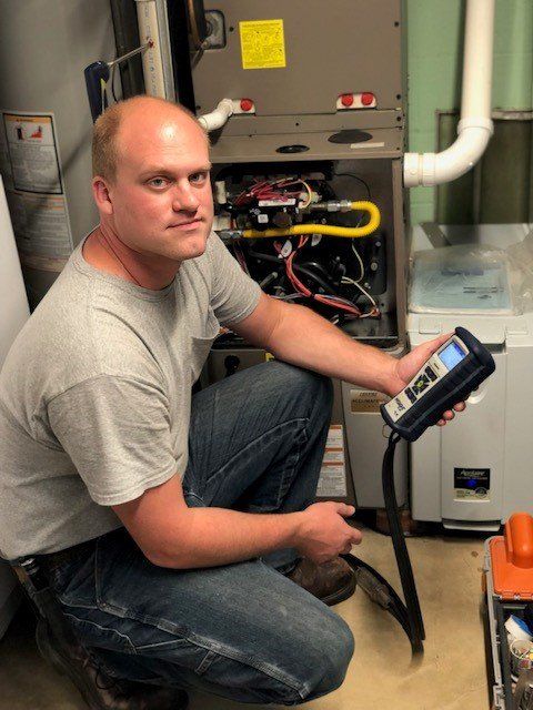 Using Device To Check The Furnace — Ashtabula, OH — Blank Heating Company Inc