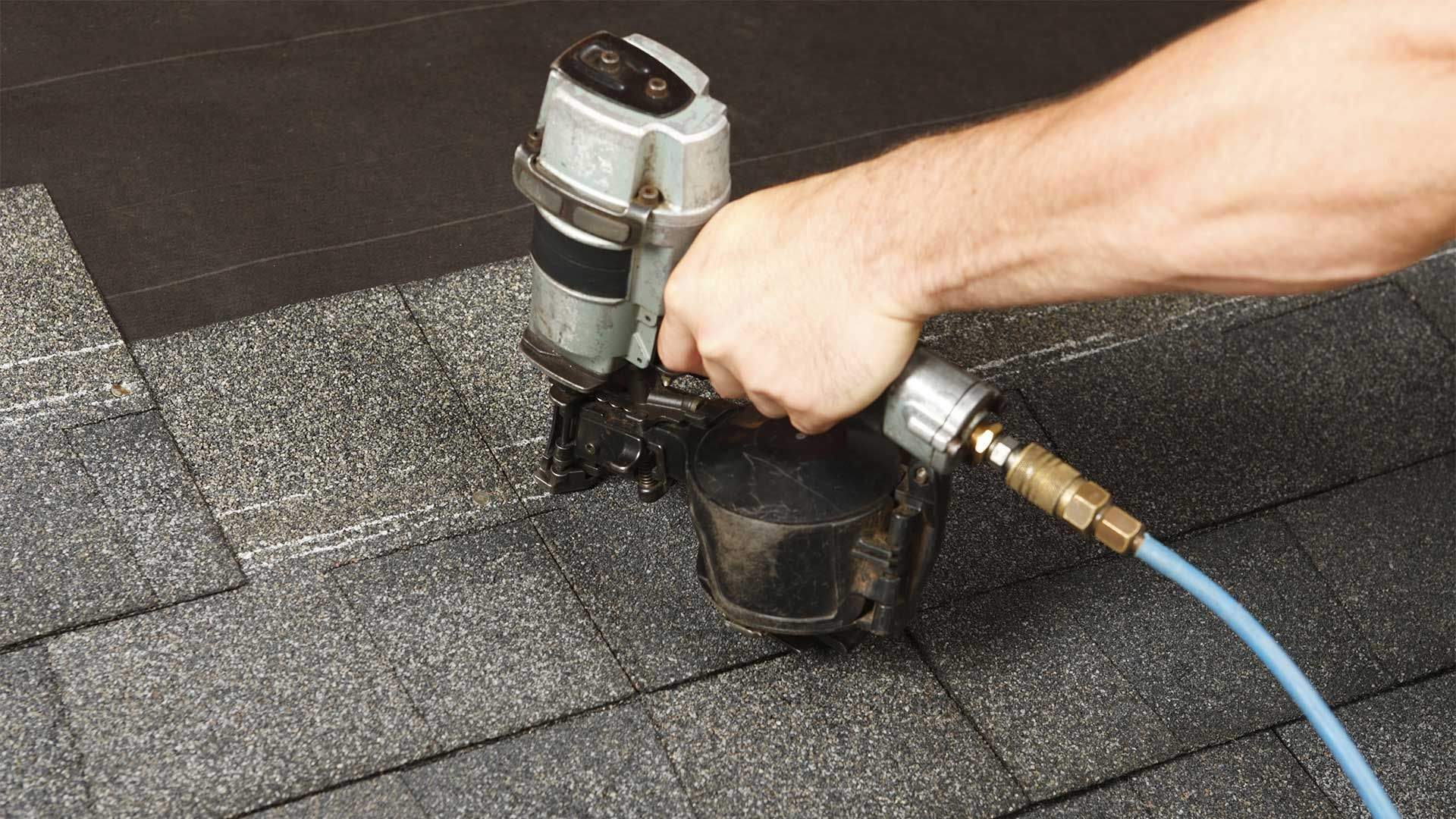 Man nailing roofing onto the roof