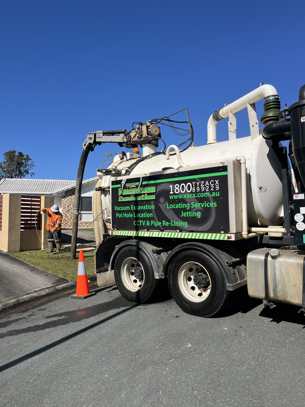 A Sewage Truck Parked on a Street With a Worker — Tyzac Group in Beerwah, QLD
