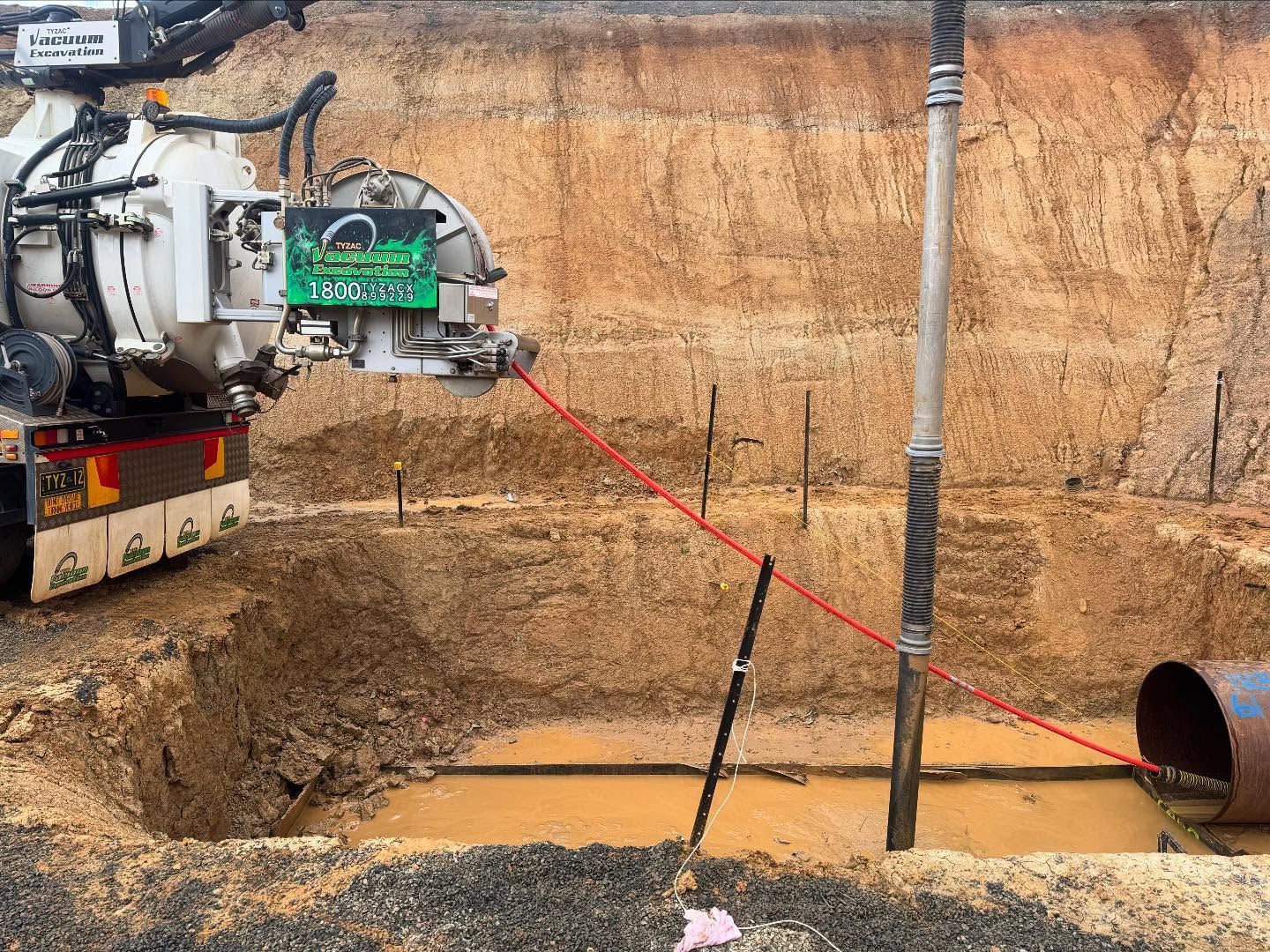 Construction equipment drilling beside exposed pipe for Vac Truck Sunshine Coast.