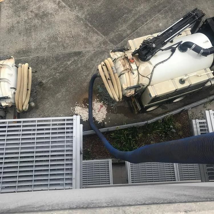 Septic Truck With Hose on a Concrete Surface, Near a Metal Gate — Tyzac Group in Beerwah, QLD