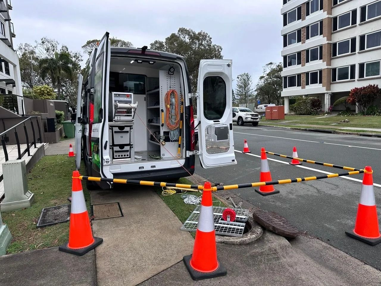Van Parked by an Open Manhole on a Street, With Cones and Barriers for Safety — Tyzac Group in Beerwah, QLD