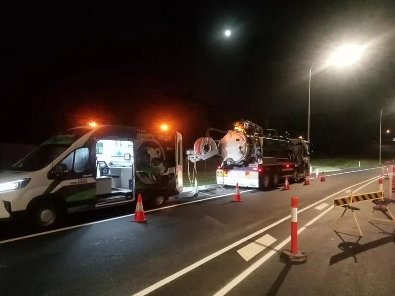 Two Service Vehicles With Lights on Parked on a Road at Night — Tyzac Group in Beerwah, QLD