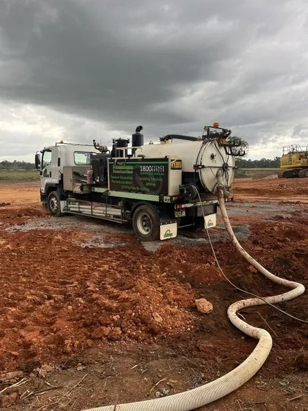 Vacuum Truck on Muddy Ground With a Cloudy Sky Overhead — Tyzac Group in Beerwah, QLD