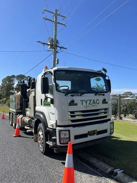 White Tyzac Truck Parked Near a Power Pole, With Orange Cones on the Road — Tyzac Group in Beerwah, QLD