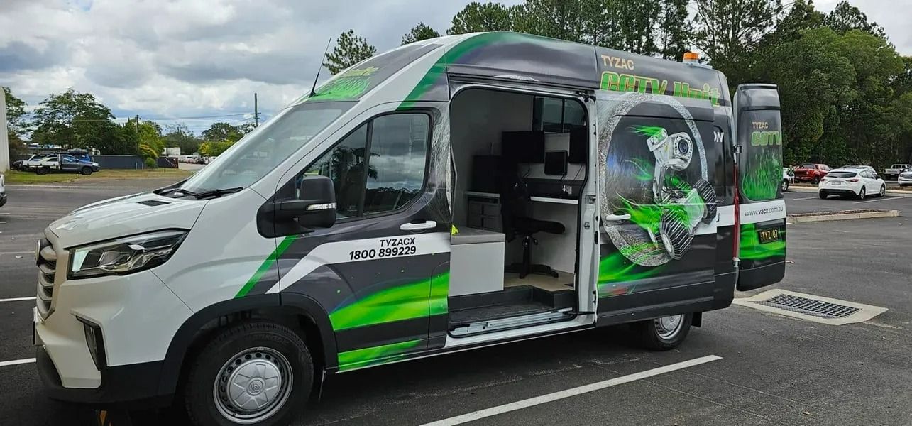 White Van With Green Accents, Parked in a Lot, Door Open to Reveal a Workspace — Tyzac Group in Beerwah, QLD
