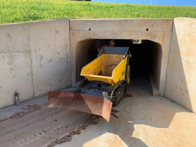 Yellow Mini-dumper Vehicle Exiting a Concrete Tunnel — Tyzac Group in Beerwah, QLD