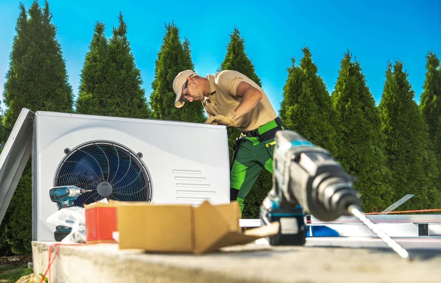 A man is working on a heat pump outside.