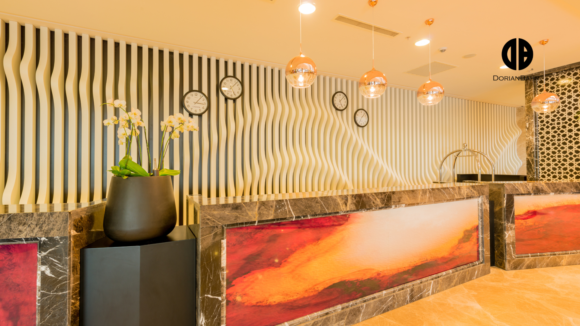 A hotel lobby with a striped wall and a painting on the wall.