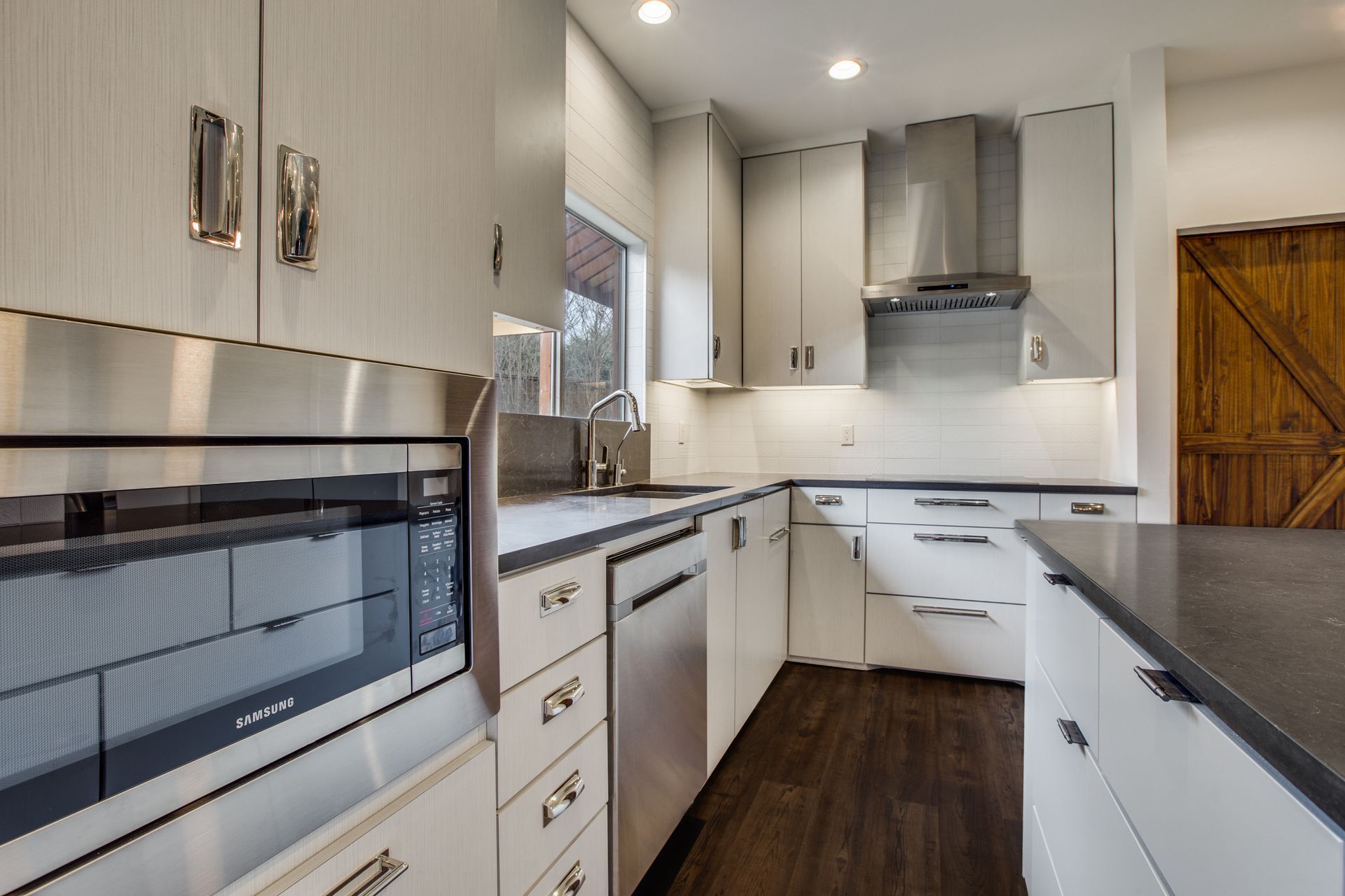 A kitchen with stainless steel appliances and white cabinets