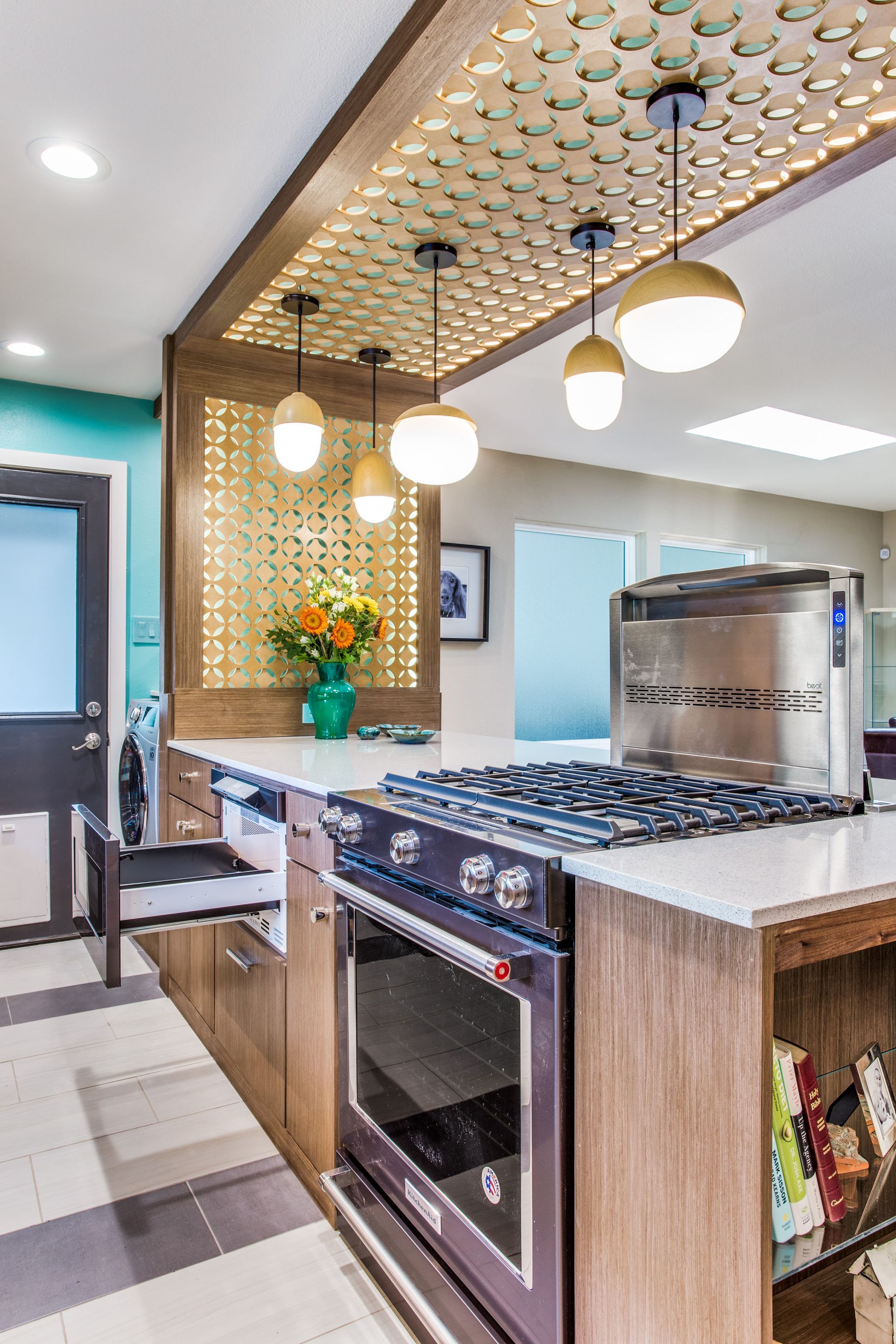 A kitchen with a stove , oven , and sink.