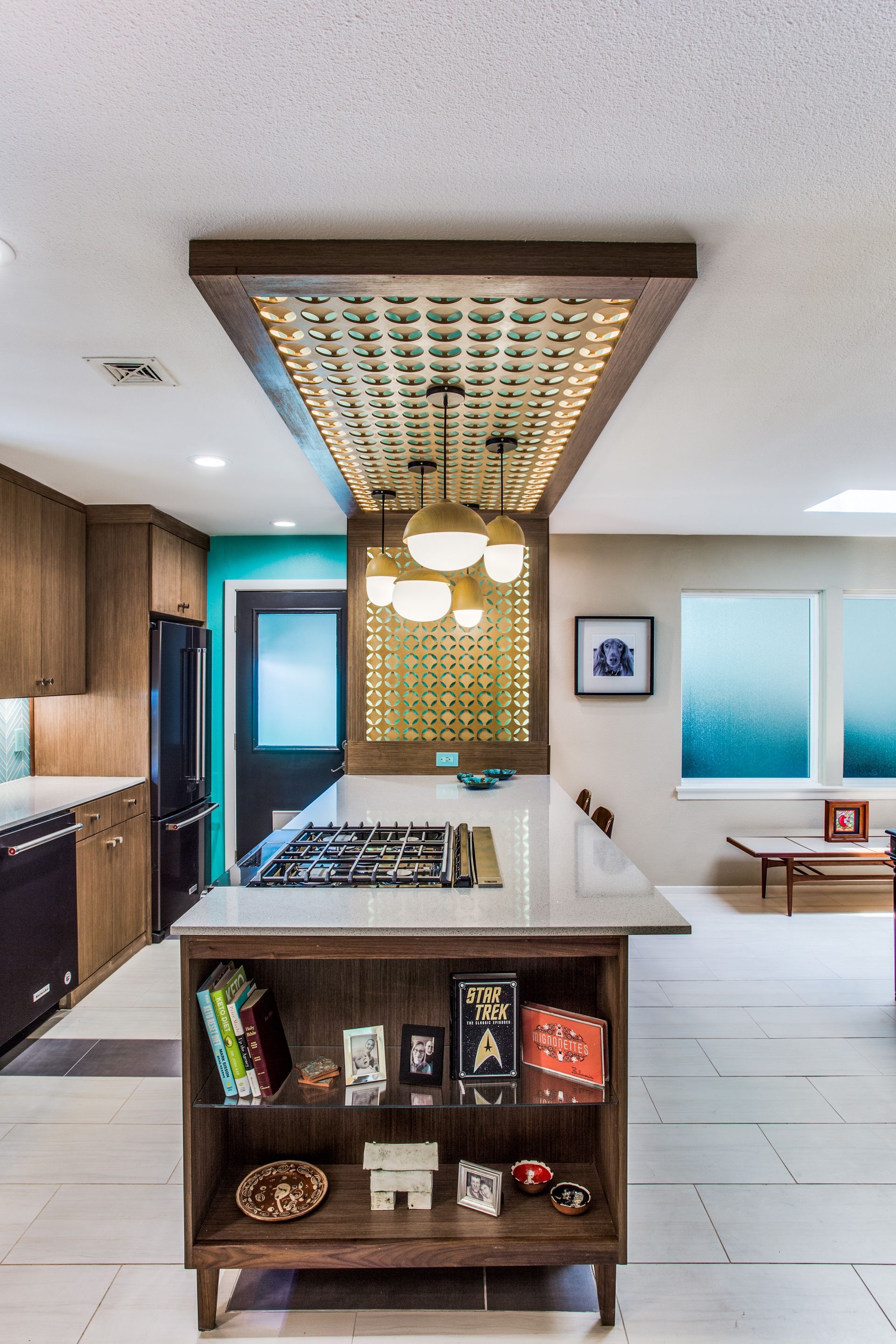 A kitchen with a large island and a stove top oven