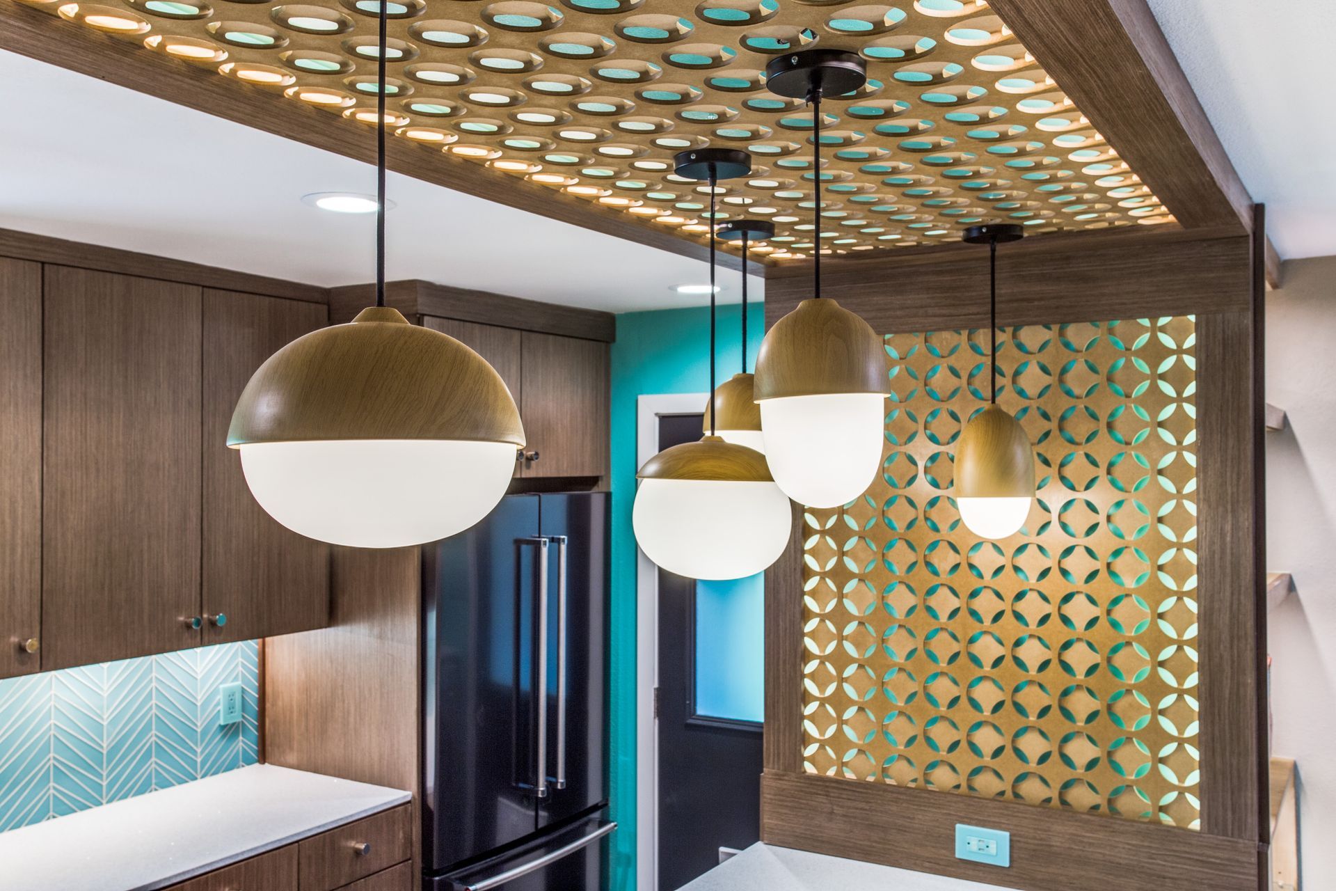 A kitchen with a lot of pendant lights hanging from the ceiling