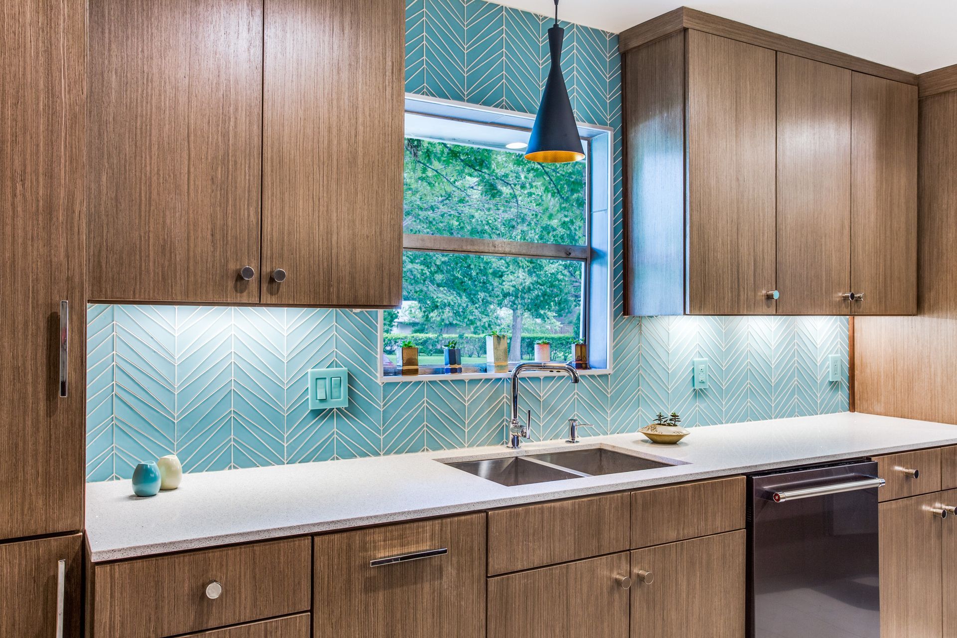 A kitchen with wooden cabinets , a sink , and a window.