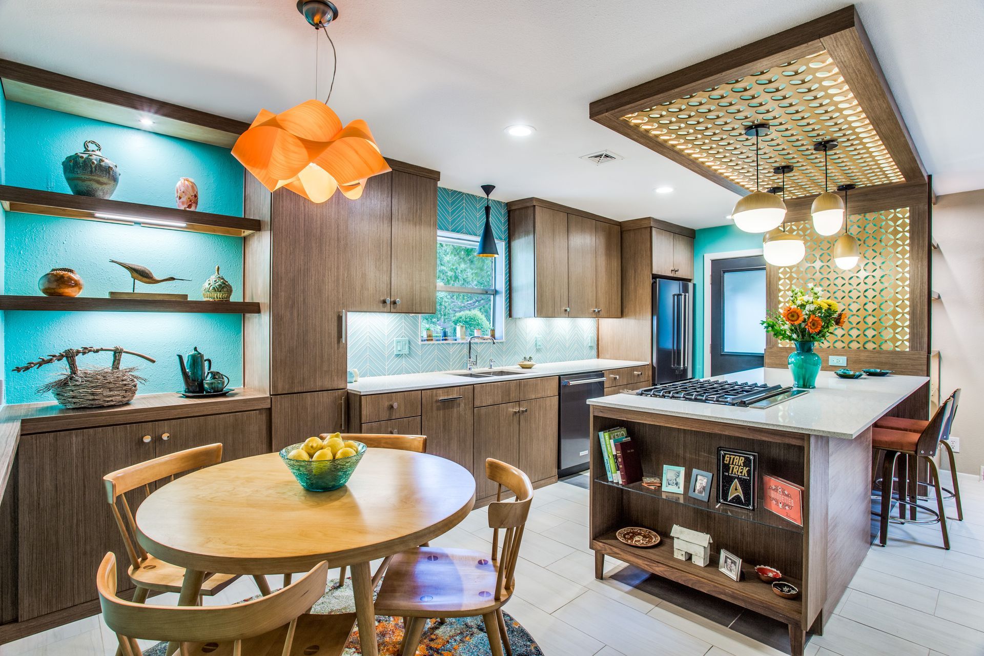 A kitchen with a table and chairs and a large island.