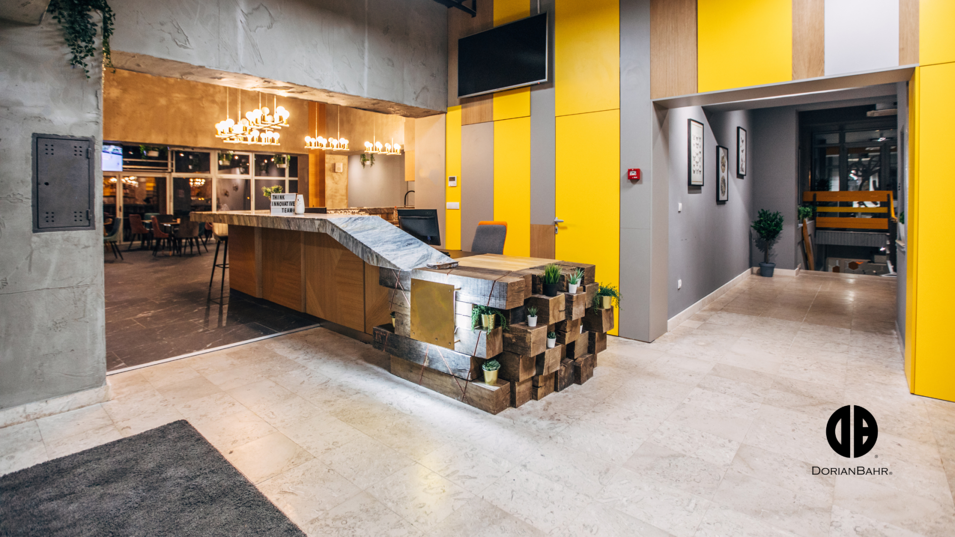 A lobby with a wooden counter and yellow walls.