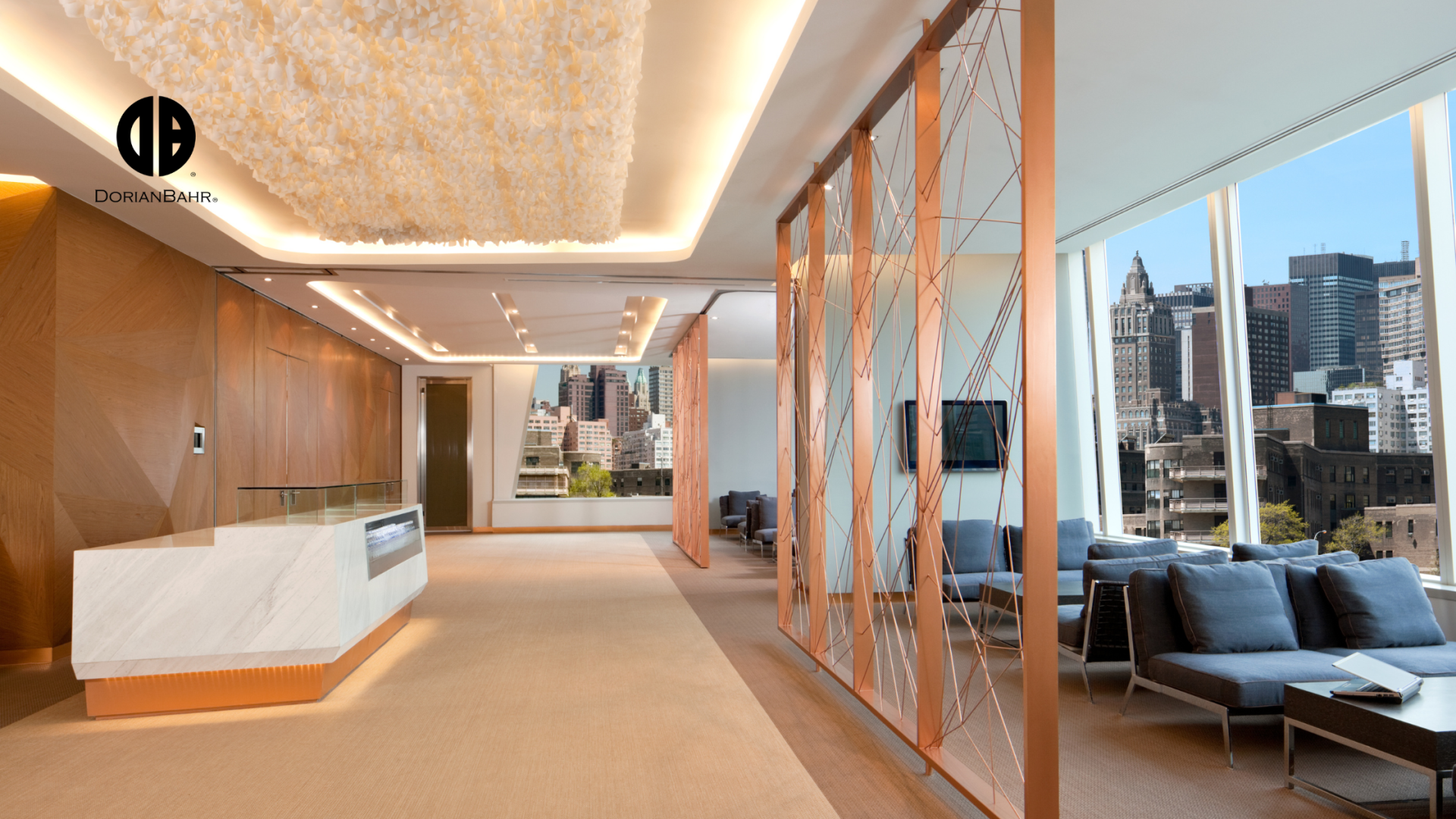 A lobby with a reception desk and a living room with a couch.