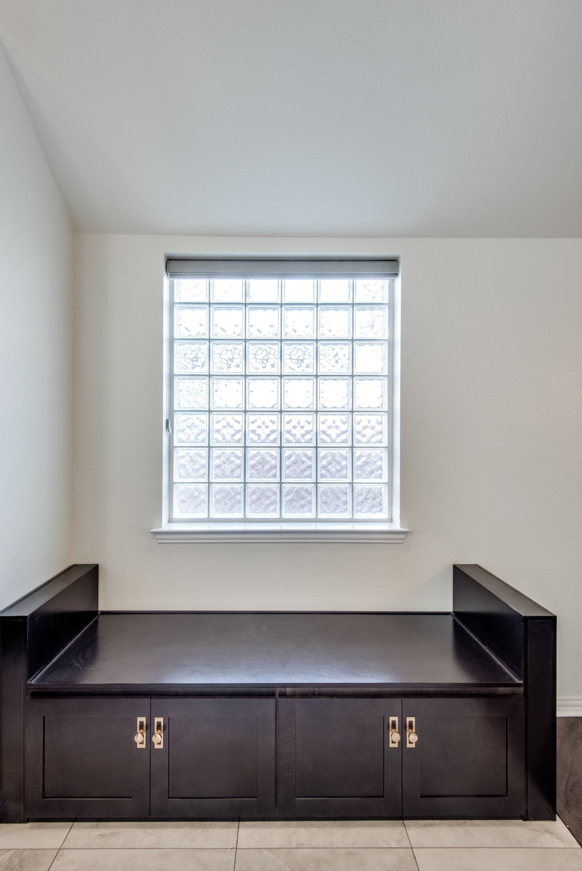 A room with a window and a couch in it
