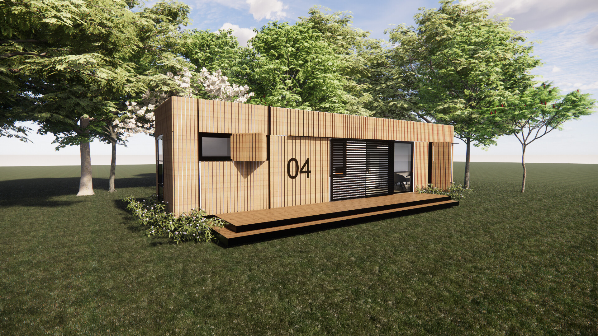 A shipping container  house is sitting on top of a lush green field surrounded by trees.