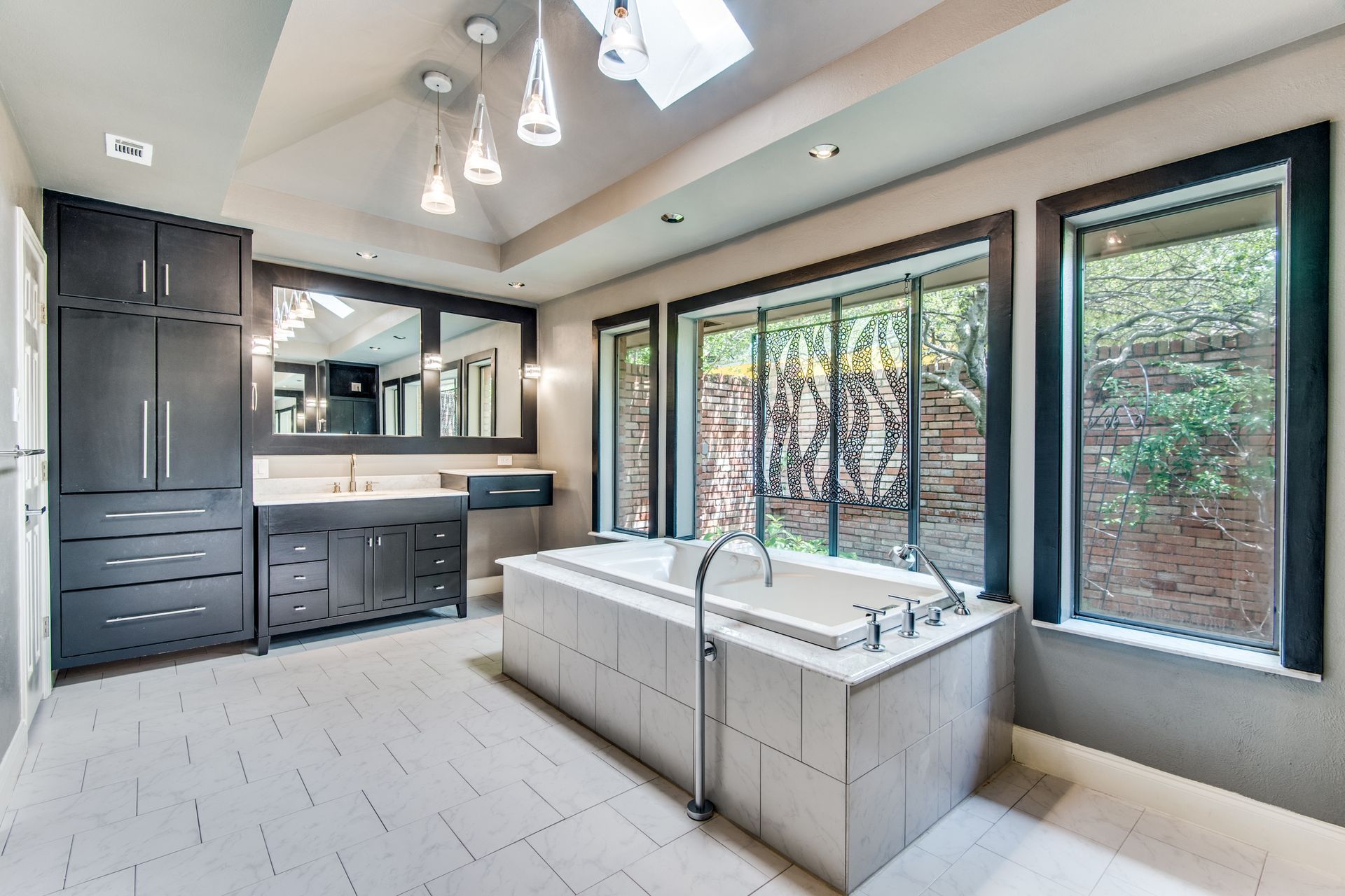 A bathroom remodel with a large tub and lots of windows