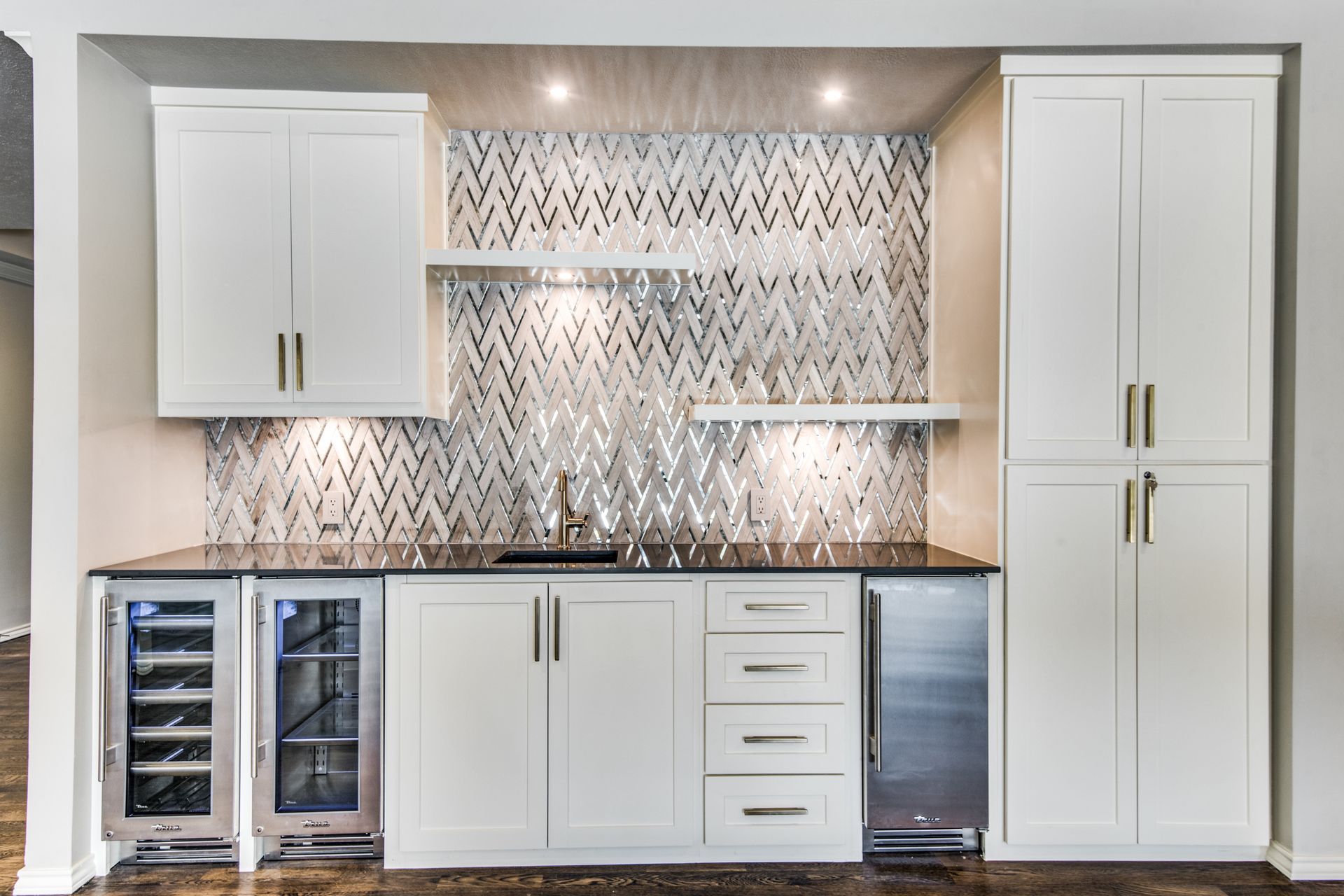 A kitchen with white cabinets and stainless steel appliances