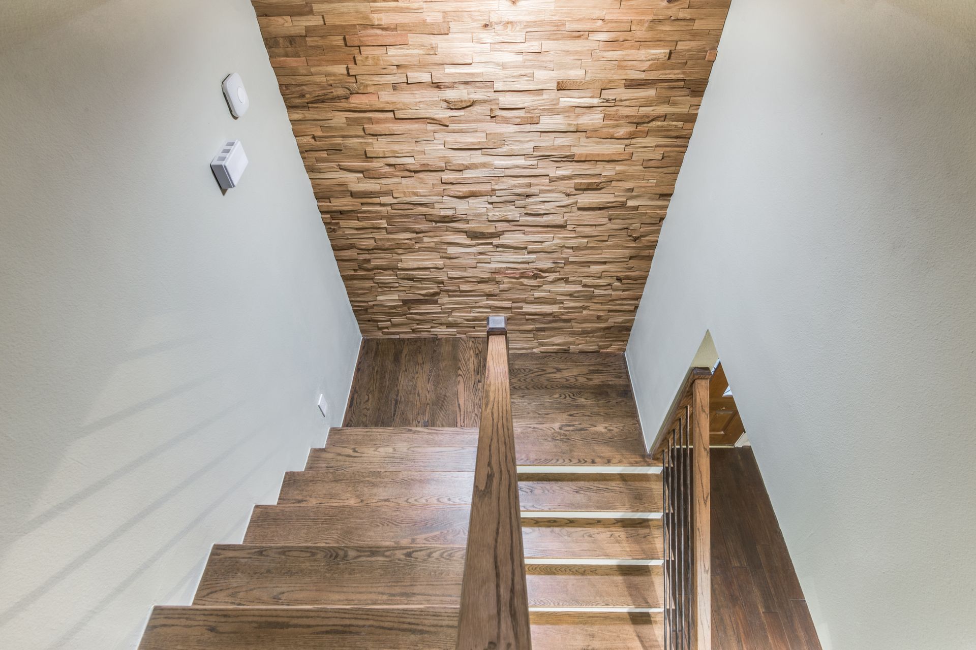 A wooden staircase with a wooden wall behind it