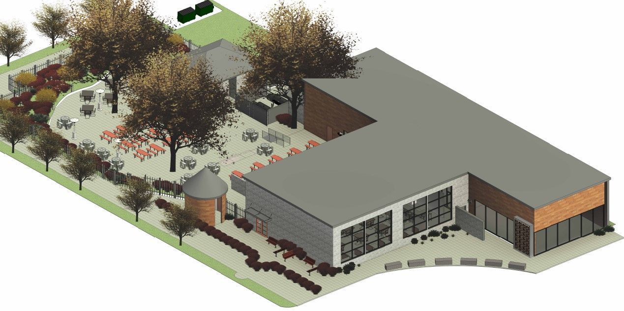An aerial view of a building with trees in front of it.