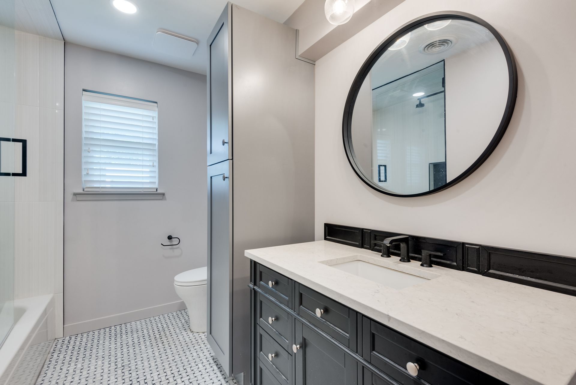 A bathroom remodel with a sink , toilet , and mirror.