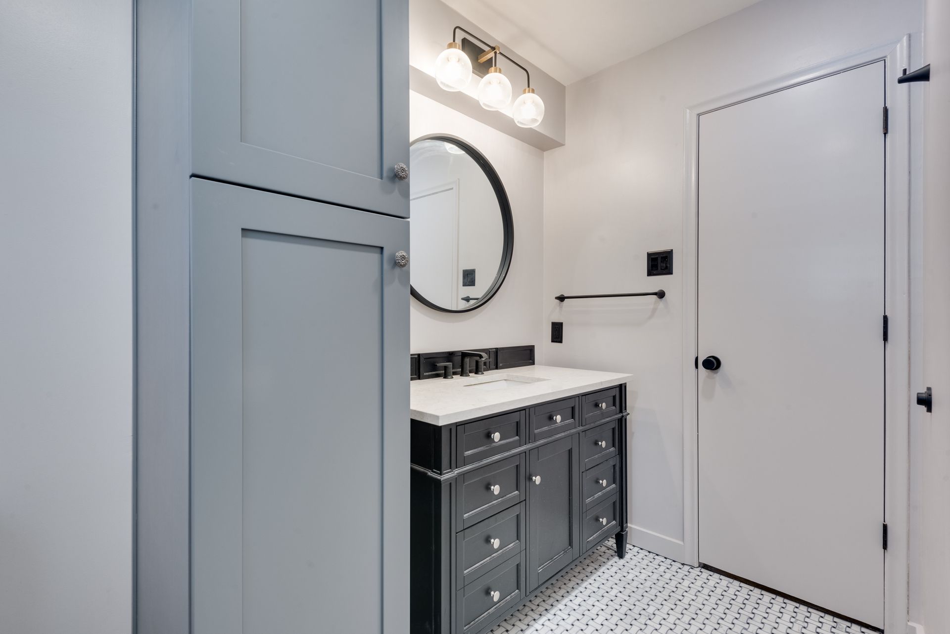 A bathroom remodel with a sink , mirror and cabinets.