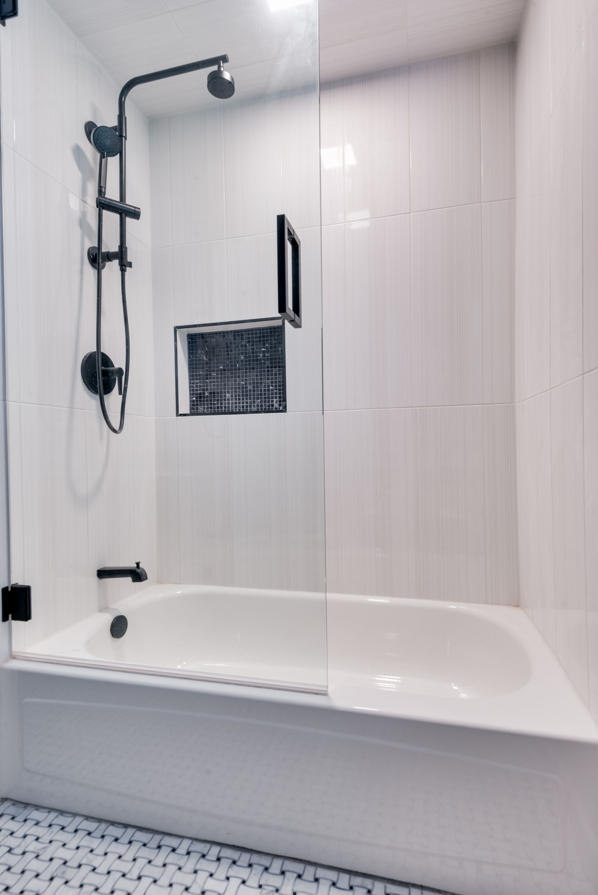 A bathroom remodel with a bathtub and a shower with a glass door.