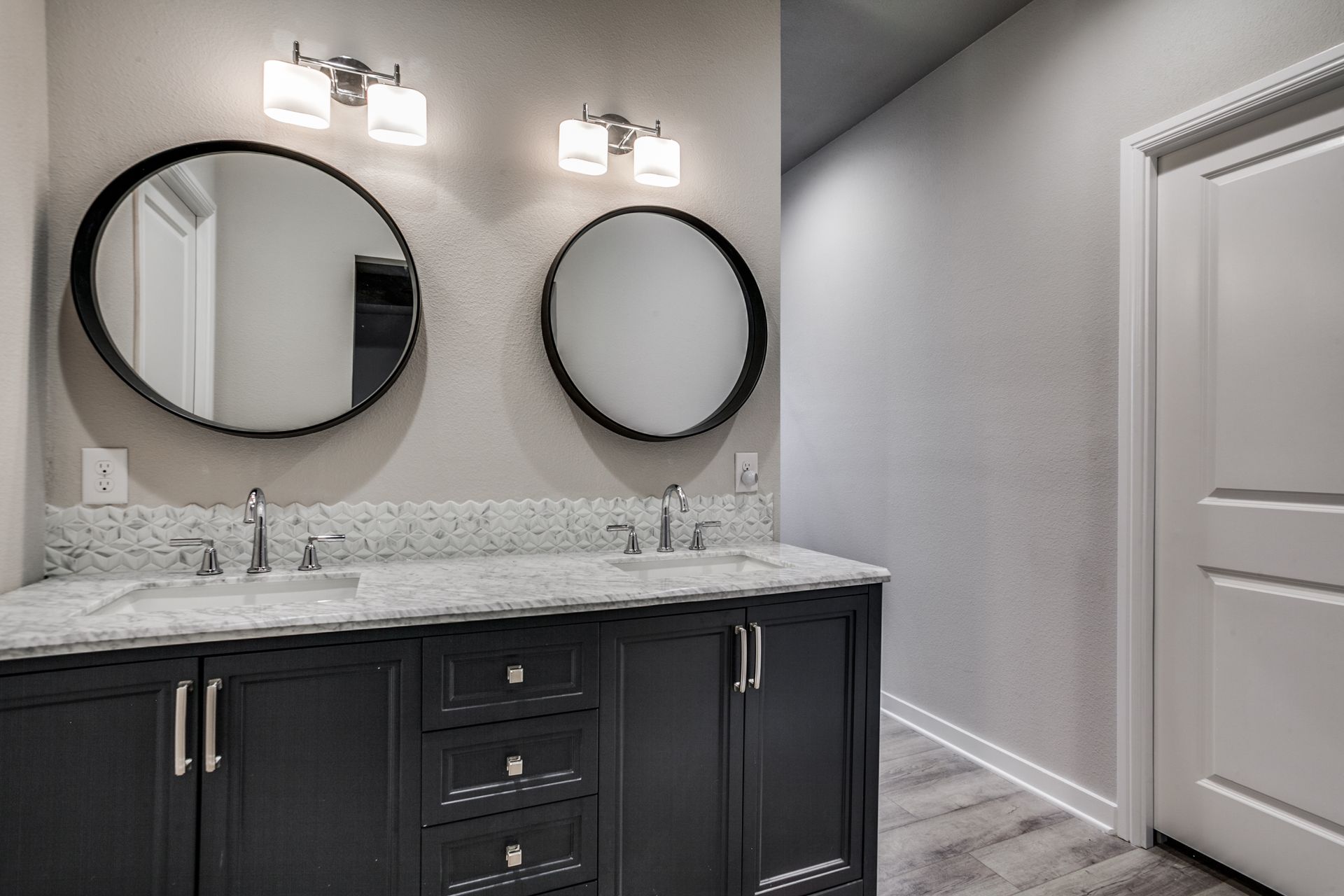 A bathroom with two sinks and two mirrors.