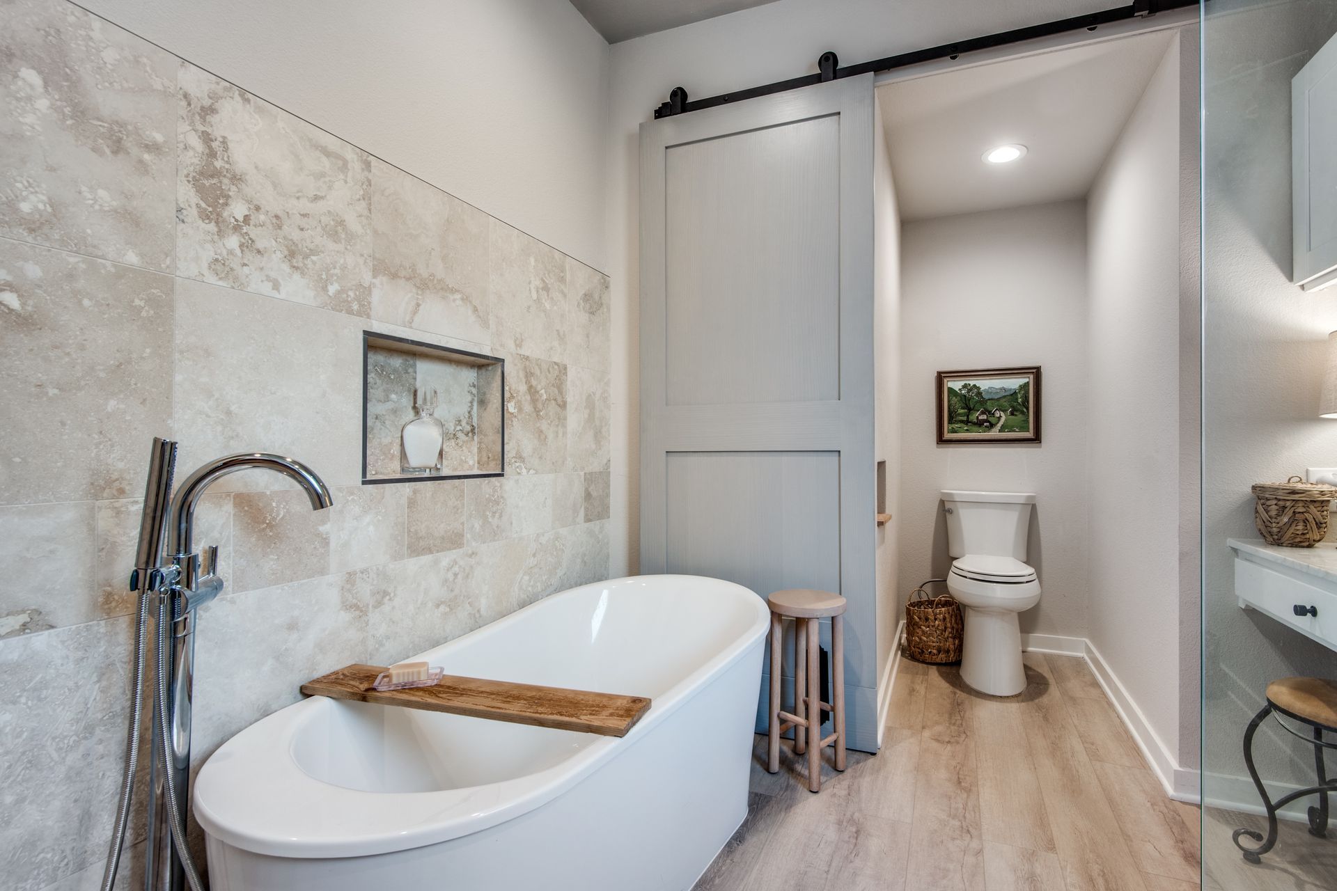A bathroom with a bathtub , toilet and sink.