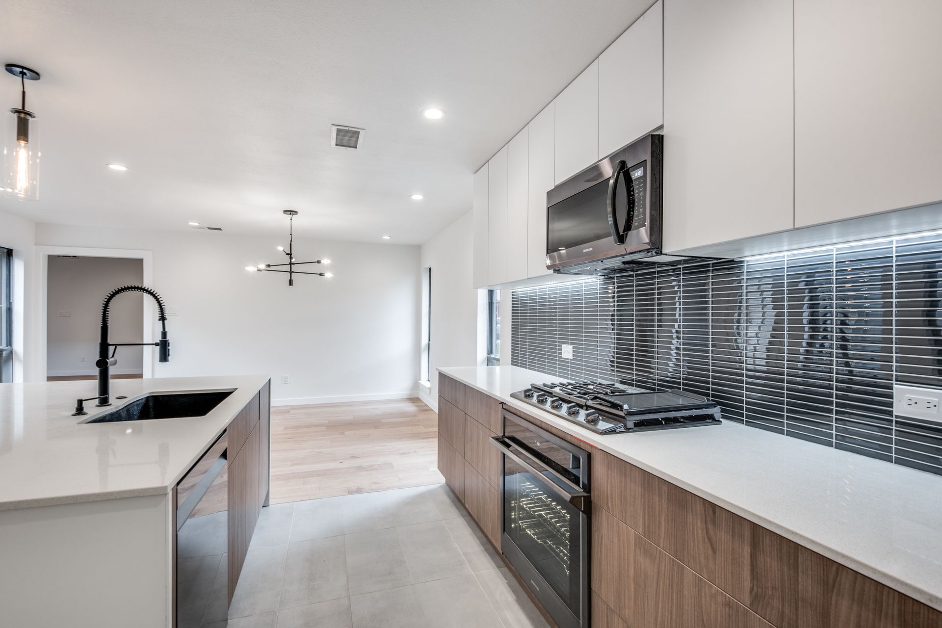 A kitchen with stainless steel appliances and wooden cabinets.