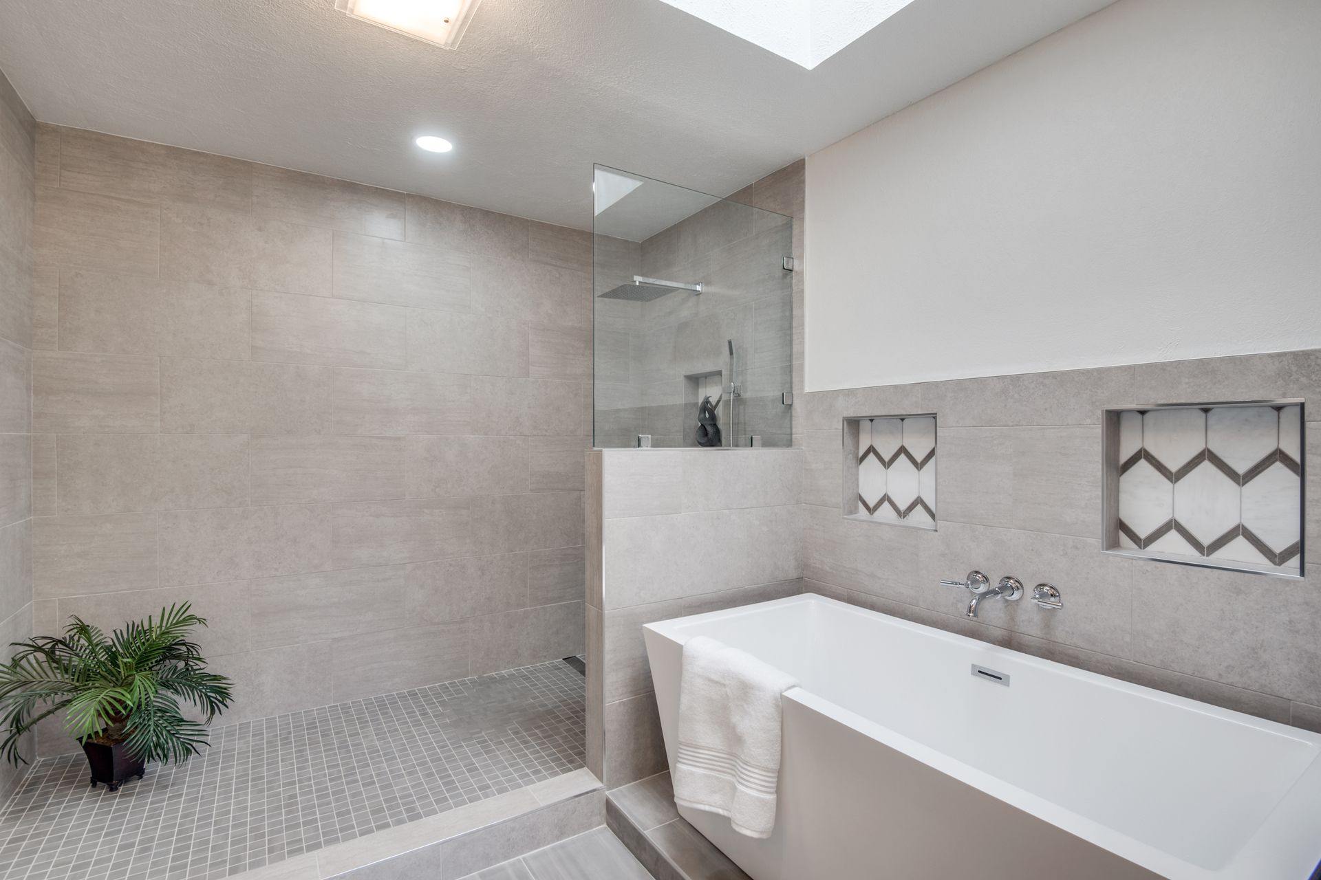 A bathroom remodel with a bathtub and a walk in shower.